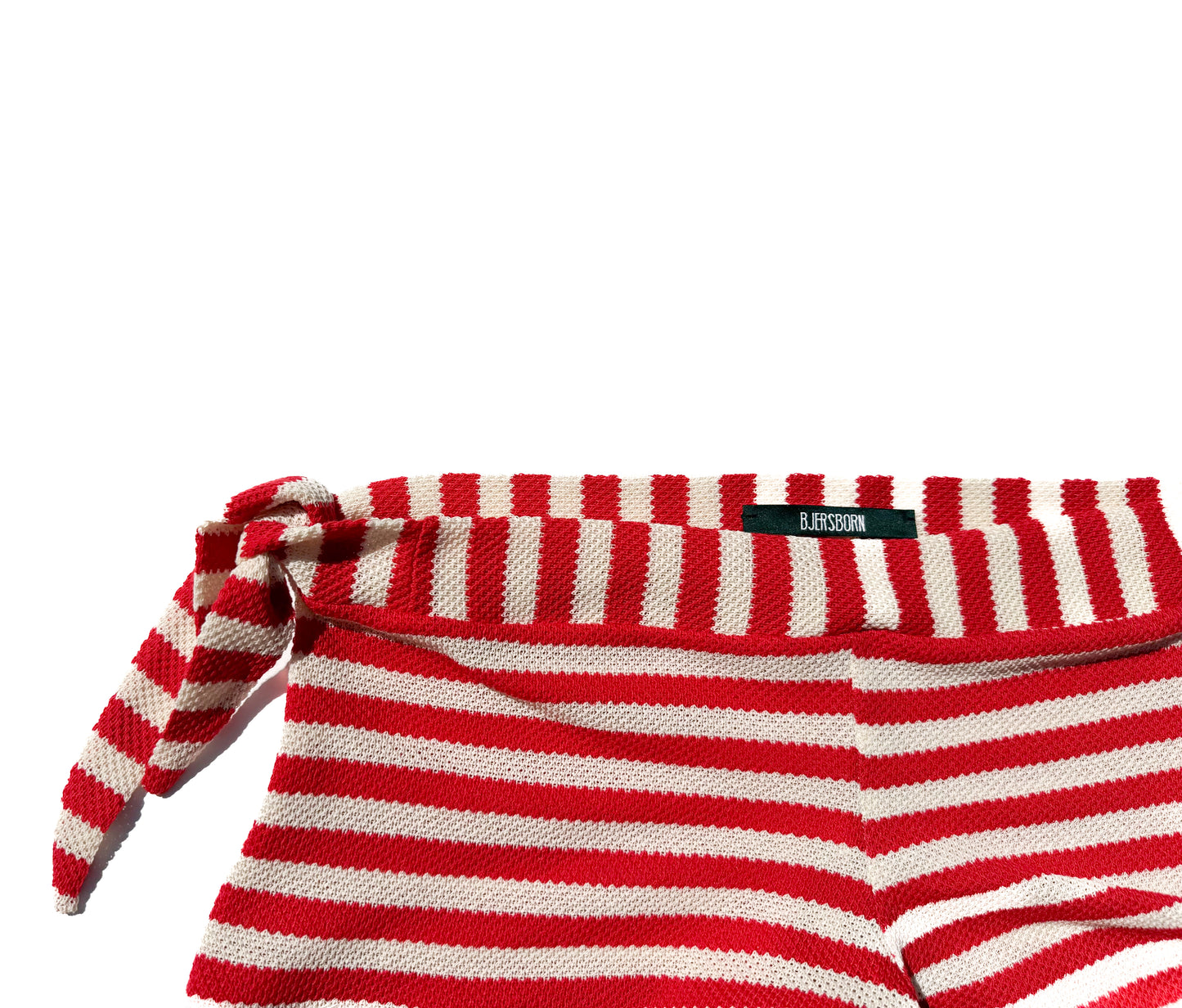 Red and white striped shorts with a brand label on a white background